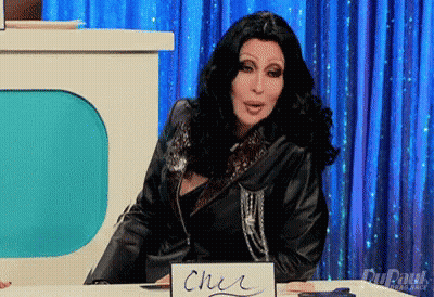 Cher At Table With Cher Sign GIF