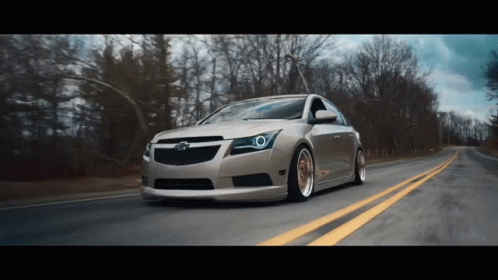 Chevrolet Car Driving Down Road With Trees GIF