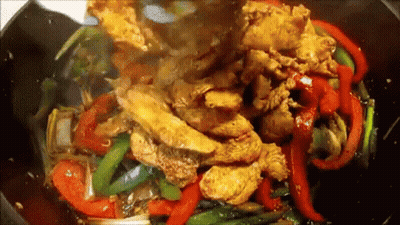Chicken And Peppers Being Cooked In Wok With Sauce GIF