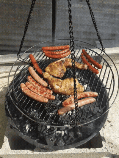 Chicken And Sausages Cooking On Grill With Hanging Chains GIF