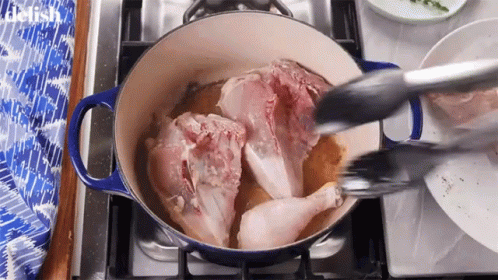 Chicken Being Cooked In Pot On Stove With Tongs GIF