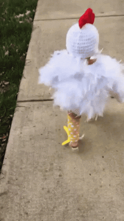 Child Dressed As Chicken Walking Down Sidewalk GIF