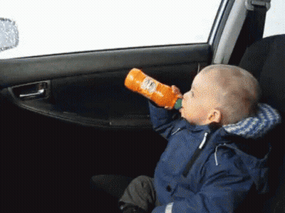 Child Drinking Orange Juice In Car GIF