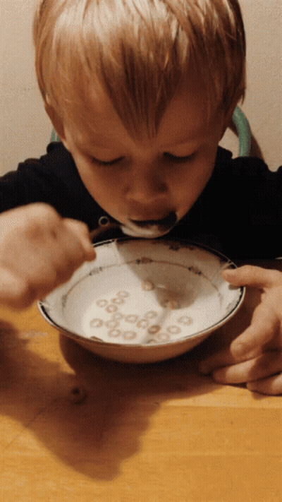 Child Eating Cereal With Spoon GIF