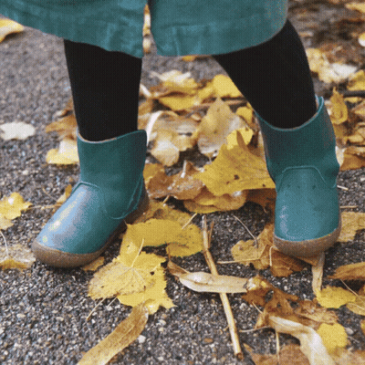 Child In Green Boots On Leaves GIF