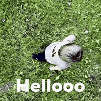 Child Laying In Grass Saying Hellooo GIF