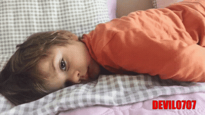 Child Laying On Bed With Devil0707 In Red Letters GIF