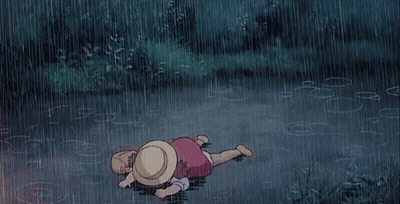 Child Laying On Ground In Rain GIF