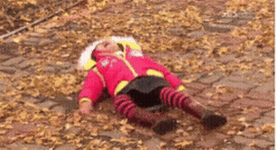 Child Lying In Leaves GIF