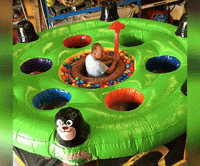 Child Playing Whack-A-Mole GIF