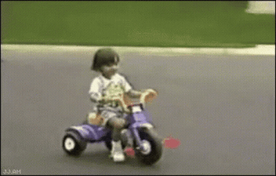 Child Riding Purple Tricycle GIF