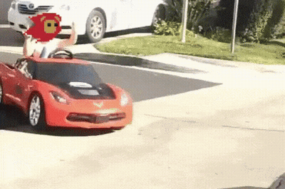Child Riding Red Toy Car On Street GIF