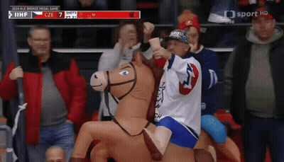 Child Riding Stuffed Horse At Hockey Game GIF