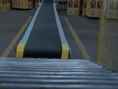 Child's Doll On Conveyor Belt In Factory GIF