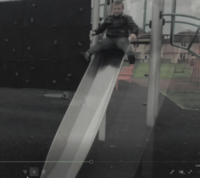 Child Sitting On Slide With Green Arrow GIF