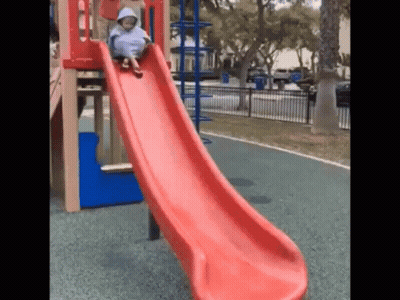 Child Sliding Down Red Slide GIF