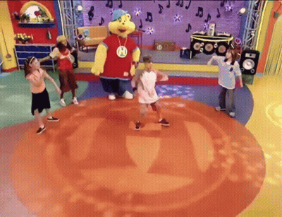 Children Dancing On Stage With Mascot Wearing H GIF