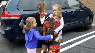 Children Hugging In Front Of Blue Van Saying Los Angeles GIF