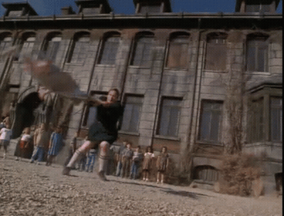 Children Playing In Front Of Old Building GIF