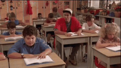 Children Sitting At Desks In Classroom GIF