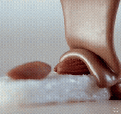 Chocolate Being Poured On Almond GIF