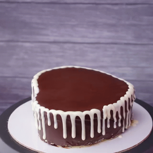 Chocolate Cake With White Frosting Drips GIF