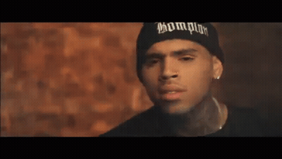 Chris Brown Is Wearing A Black Beanie And Earrings . GIF