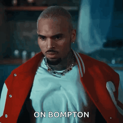 Chris Brown Is Wearing A Red And White Varsity Jacket And A White T-Shirt . GIF