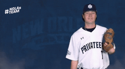 Chris Turpin Throws Baseball In Front Of Nolas Team Logo GIF