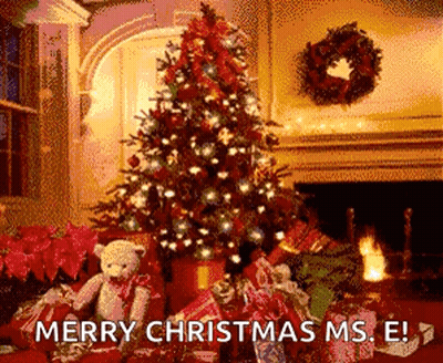 Christmas Tree Next To Fireplace And Gifts GIF
