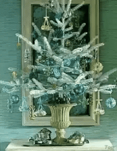 Christmas Tree With Blue Ornaments In Gold Vase GIF