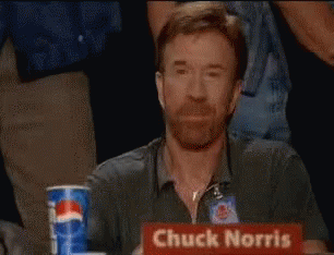 Chuck Norris Is Sitting At A Table With A Pepsi Can In Front Of Him GIF