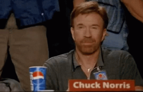 Chuck Norris Is Sitting At A Table With A Pepsi Cup In Front Of Him GIF