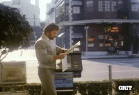 Chuck Norris Thumbs Up Reading Newspaper Punch GIF