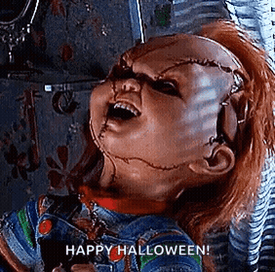 Chucky From Childs Play Is Holding A Pair Of Scissors In His Hand And Says `` Happy Halloween '' . GIF