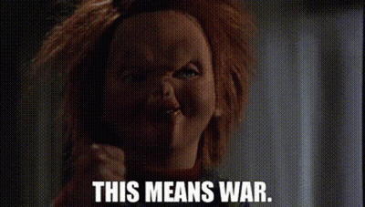 Chucky From Childs Play Is Making A Funny Face And Says `` This Means War '' . GIF