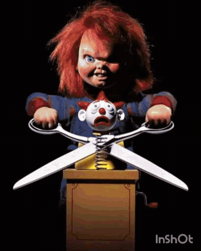 Chucky Holding Scissors Over Clown Doll GIF
