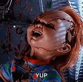 Chucky Holding Scissors With Mouth Open GIF