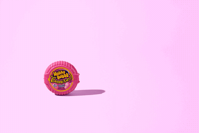Chupa Chups Gum Roll On Pink Surface GIF