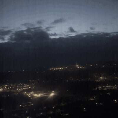 City At Night With Cloudy Sky GIF