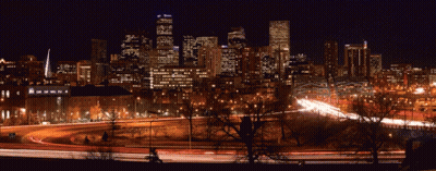City Skyline At Night With Highway And Trees GIF