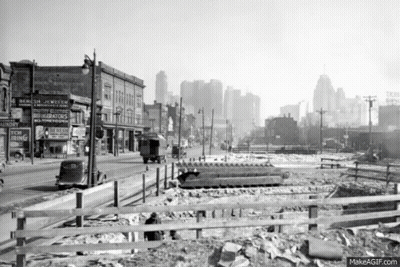 City Street With Fence And New Ring Sign GIF