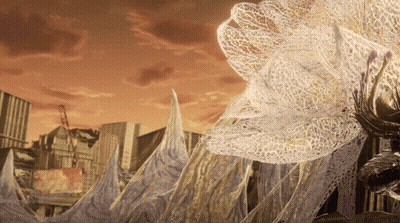 City With Large White Flower In Foreground GIF