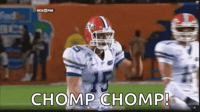 Clemson Football Players in Orange Uniforms With Trophy