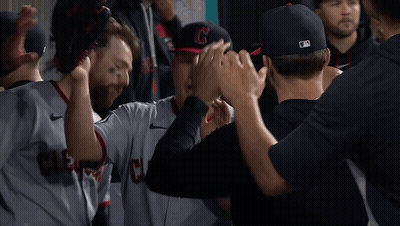 Cleveland Baseball Players High Five In Dugout GIF