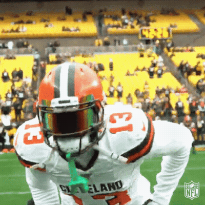 Cleveland Football Player Holding Green Object In Mouth GIF