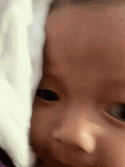 Close Up Baby Face With White Blanket GIF