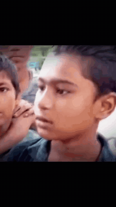 Close Up Boy Face With Group Behind GIF