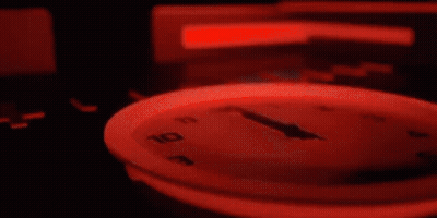 Close Up Clock With Red Light Around Face GIF