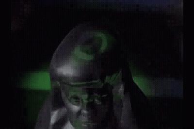 Close Up Face In Camouflage Uniform In Dark GIF